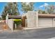 Home exterior showing low-maintenance desert landscaping, gated entry, and attached two-car garage at 7126 N Via Nueva --, Scottsdale, AZ 85258