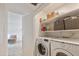 Convenient laundry room with washer, dryer, and shelving units for storage space at 7126 N Via Nueva --, Scottsdale, AZ 85258