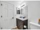 Well-lit bathroom featuring a dark wood vanity with double sinks and a walk-in shower at 7905 W Thunderbird Rd # 308, Peoria, AZ 85381