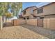 Townhome exterior featuring a private, graveled backyard with gated access at 7905 W Thunderbird Rd # 308, Peoria, AZ 85381