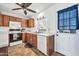 Well-lit kitchen featuring wood cabinets, white countertops, and modern appliances at 7905 W Thunderbird Rd # 308, Peoria, AZ 85381