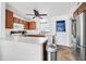 Well-equipped kitchen featuring wood cabinets, white countertops, and modern appliances at 7905 W Thunderbird Rd # 308, Peoria, AZ 85381