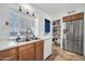 Bright kitchen with stainless steel refrigerator and double sink overlooking the backyard at 7905 W Thunderbird Rd # 308, Peoria, AZ 85381