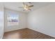 Bright bedroom featuring wood-look flooring, white walls, and a window with blinds at 840 E Hackamore St, Mesa, AZ 85203