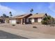 Single-story home featuring desert landscaping, a brick accent wall, and a two-car garage at 840 E Hackamore St, Mesa, AZ 85203