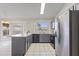 Galley kitchen with painted cabinets, tile floors, a breakfast bar, and stainless-steel appliances at 840 E Hackamore St, Mesa, AZ 85203