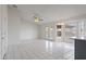 An open-plan living and dining room featuring tile flooring, a ceiling fan, and bright natural light at 840 E Hackamore St, Mesa, AZ 85203