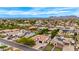 Expansive aerial view of a residential neighborhood, showcasing the homes, landscaping, and mountain views at 8418 W Louise Ct, Peoria, AZ 85383