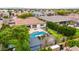 Aerial shot showcasing backyard, featuring a pool, patio, and mini putting green nestled among mature landscaping at 8418 W Louise Ct, Peoria, AZ 85383