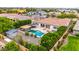 Aerial view of a backyard featuring a sparkling pool, shaded pergola, putting green and manicured landscaping at 8418 W Louise Ct, Peoria, AZ 85383