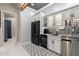 Home bar area featuring custom cabinets, wine storage, and stylish backsplash at 8418 W Louise Ct, Peoria, AZ 85383