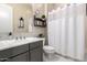 Well-maintained bathroom with a vanity, mirror, and shower curtain at 8418 W Louise Ct, Peoria, AZ 85383