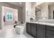 Bright bathroom featuring double sinks, soaking tub, and elegant finishes at 8418 W Louise Ct, Peoria, AZ 85383