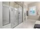 Bathroom with a large glass shower door and clean white tiles at 8418 W Louise Ct, Peoria, AZ 85383