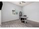 Neutral bedroom features hardwood floors and a desk for a modern workspace at 8418 W Louise Ct, Peoria, AZ 85383