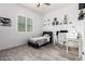 Bright bedroom with a gray bed and a modern desk space at 8418 W Louise Ct, Peoria, AZ 85383