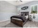 Comfortable bedroom with stylish decor, wood-look flooring, and plantation shutters at 8418 W Louise Ct, Peoria, AZ 85383