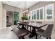 Dining room with stylish pendant lighting, plantation shutters, and sliding door to the outdoor living area at 8418 W Louise Ct, Peoria, AZ 85383