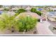 Stunning single-Gathering home with a terracotta roof, mature landscaping, and a circular driveway at 8418 W Louise Ct, Peoria, AZ 85383