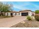 Beautiful property showcasing a long brick driveway, well-manicured landscaping, and a two-car garage at 8418 W Louise Ct, Peoria, AZ 85383