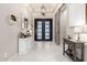 Elegant foyer with a modern chandelier, striking decor, and ample natural light, creating an inviting entrance at 8418 W Louise Ct, Peoria, AZ 85383