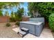 Relax and unwind in this backyard hot tub surrounded by lush landscaping and mature trees at 8418 W Louise Ct, Peoria, AZ 85383