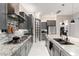 Modern kitchen featuring gray cabinets, stainless steel appliances, and a stylish backsplash at 8418 W Louise Ct, Peoria, AZ 85383