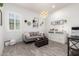 Inviting living room featuring wood floors, natural lighting and modern decor at 8418 W Louise Ct, Peoria, AZ 85383