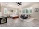 Expansive main bedroom featuring a sitting area, plantation shutters, and wood-style tile flooring at 8418 W Louise Ct, Peoria, AZ 85383