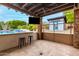 The outdoor bar, complete with seating, is perfect for entertaining by the pool at 8418 W Louise Ct, Peoria, AZ 85383