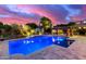 A luxurious pool featuring blue lighting and a soothing waterfall creates an oasis for relaxation at 8418 W Louise Ct, Peoria, AZ 85383