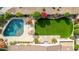 Aerial view of backyard with pool, patio seating, manicured lawn, desert landscaping, and ample privacy at 9955 E Celtic Dr, Scottsdale, AZ 85260