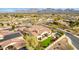 Aerial view of a desert home featuring a pool, solar panels, and mountain views at 9955 E Celtic Dr, Scottsdale, AZ 85260