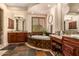 A luxurious bathroom featuring a soaking tub, dual vanities, and elegant tile work at 9955 E Celtic Dr, Scottsdale, AZ 85260