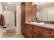 Well-appointed bathroom features a granite countertop, wood cabinets, and a glass-enclosed shower for a spa-like experience at 9955 E Celtic Dr, Scottsdale, AZ 85260