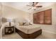 A serene bedroom with neutral tones, plush carpeting, and a ceiling fan for added comfort at 9955 E Celtic Dr, Scottsdale, AZ 85260