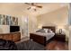 Cozy bedroom with hardwood floors, a dark wood bed frame and access to a private doorway at 9955 E Celtic Dr, Scottsdale, AZ 85260