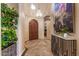 Grand foyer showcasing tile flooring, arched wood door, and a stunning chandelier at 9955 E Celtic Dr, Scottsdale, AZ 85260