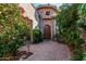 Charming courtyard with stone accents, brick pavers, and a wooden entry door at 9955 E Celtic Dr, Scottsdale, AZ 85260