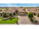 Charming front exterior showcasing manicured lawn, stone accents, tile roof, and a circular driveway at 9955 E Celtic Dr, Scottsdale, AZ 85260