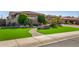 Charming home with lush green lawn, manicured landscaping, and a paver walkway at 9955 E Celtic Dr, Scottsdale, AZ 85260