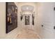 Hallway featuring neutral decor, artwork, tile flooring, and decorative lighting at 9955 E Celtic Dr, Scottsdale, AZ 85260