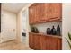 Beautiful hallway featuring built-in wooden cabinets and neutral decor at 9955 E Celtic Dr, Scottsdale, AZ 85260