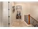 Upstairs hallway featuring beautiful archway and staircase with iron railing and wooden banister at 9955 E Celtic Dr, Scottsdale, AZ 85260