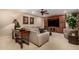 Comfortable living room featuring a neutral color palette, plush sofa, custom built-in media center, and elegant decor at 9955 E Celtic Dr, Scottsdale, AZ 85260