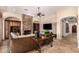 Open-concept living room with a stone fireplace, built-in shelves, and travertine floors at 9955 E Celtic Dr, Scottsdale, AZ 85260