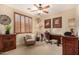 Bright home office featuring a ceiling fan, wooden shutters, and a traditional wooden desk and matching furniture at 9955 E Celtic Dr, Scottsdale, AZ 85260