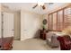 Comfortable office space with wooden shutters, neutral tones, closet, and traditional desk in home at 9955 E Celtic Dr, Scottsdale, AZ 85260