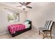 Bedroom showcasing a comfortable bed and decorative chair, illuminated by natural light at 1004 S Ironwood Dr, Apache Junction, AZ 85120