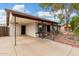 Well-maintained single-story home with covered parking and mature desert landscaping at 1004 S Ironwood Dr, Apache Junction, AZ 85120